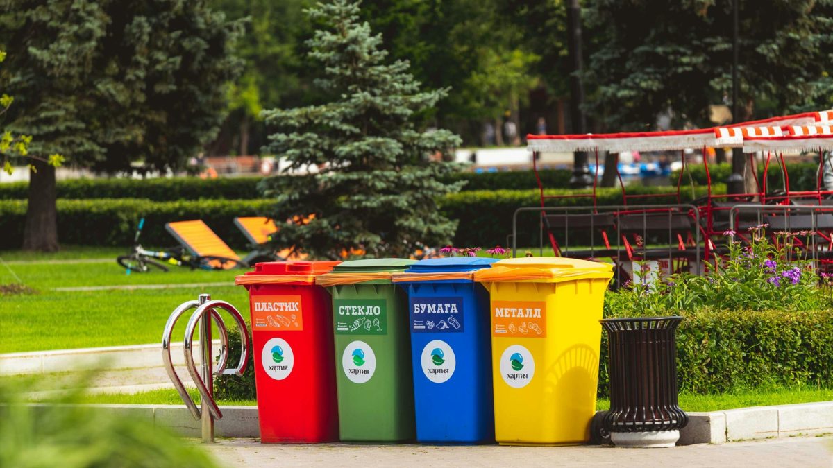 Colorful recycling bins for waste segregation in a Moscow park.